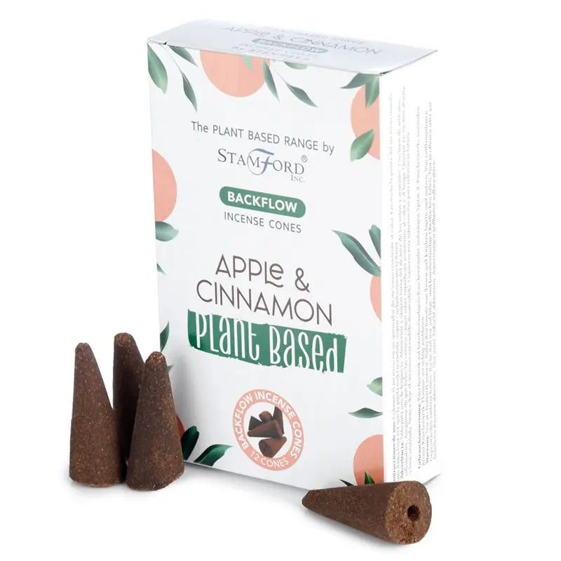 "Plant Based Backflow Incense Cones Apple & Cinnamon by Stamford Inc with white botanical packaging featuring soft peach circles and green leaf design, displayed with natural brown backflow incense cones"