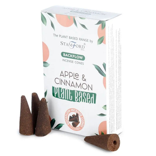 "Plant Based Backflow Incense Cones Apple & Cinnamon by Stamford Inc with white botanical packaging featuring soft peach circles and green leaf design, displayed with natural brown backflow incense cones"