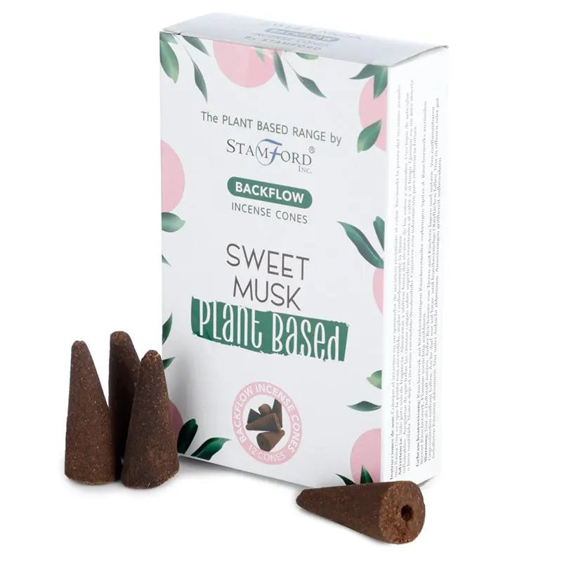 "Plant Based Backflow Incense Cones Sweet Musk by Stamford Inc with white botanical packaging featuring soft pink circles and green leaf design, displayed with natural brown backflow incense cones"