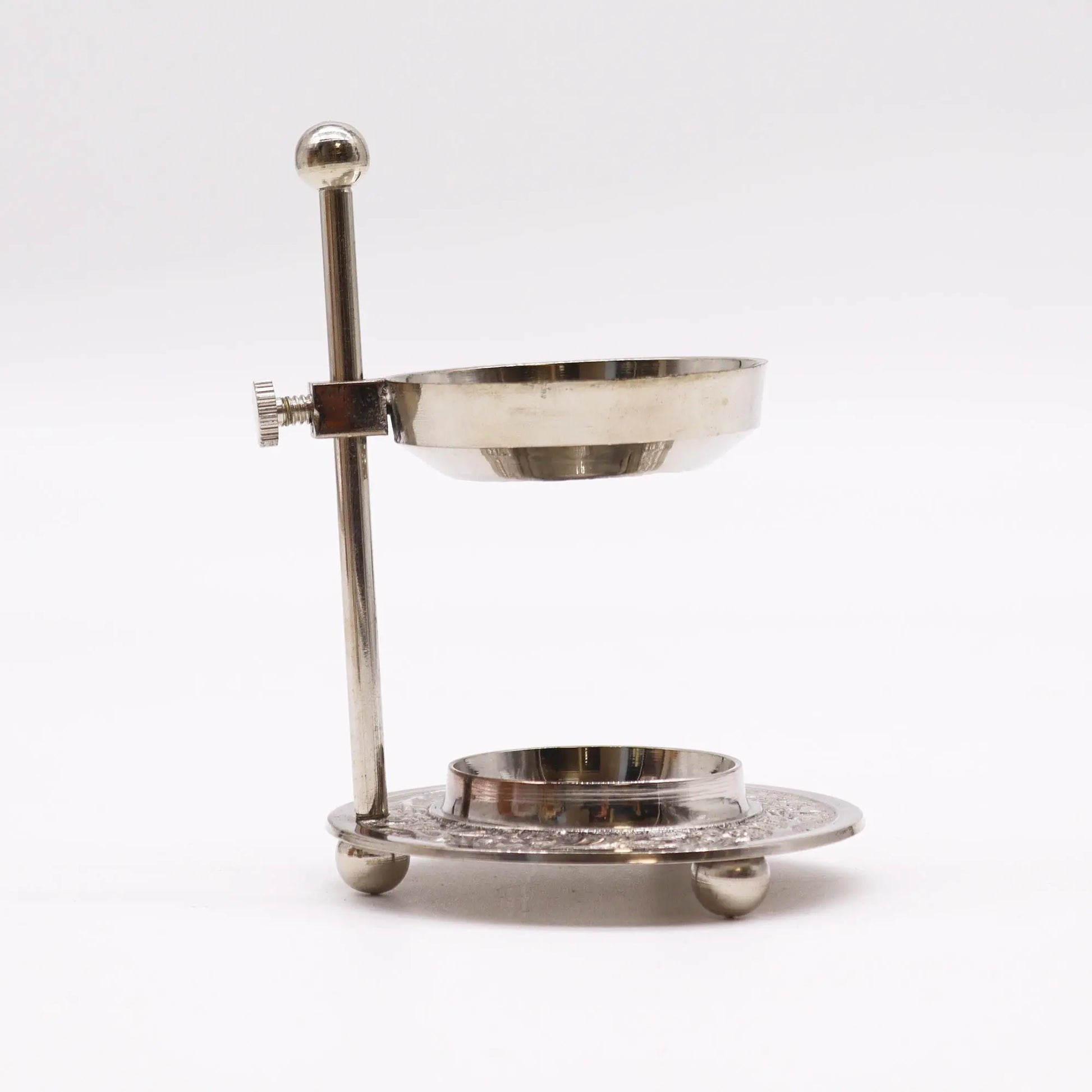 "Plated Brass Resin Incense Warmer side view showing adjustable height mechanism with chrome arm and ornate decorative base with intricate carved patterns"
