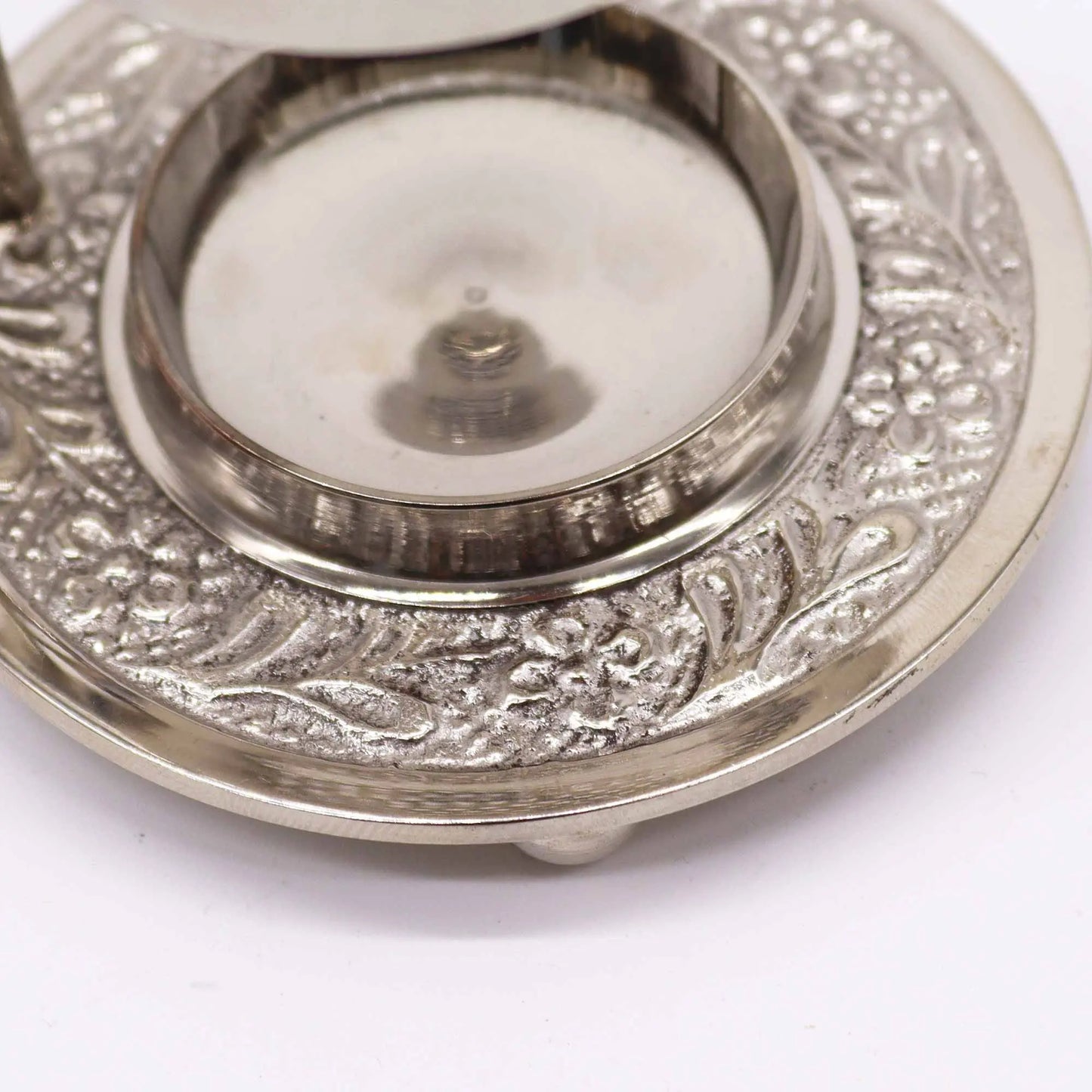 "Plated Brass Resin Incense Warmer close-up showing intricate carved decorative patterns on chrome-plated base with central candle well and detailed metalwork"