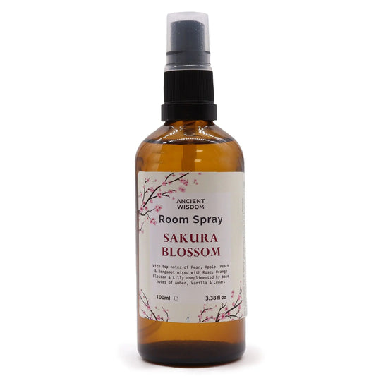 "Sakura Blossom Room Spray 100ml Ancient Wisdom amber bottle showing detailed label with pear, apple, peach, bergamot, rose, orange blossom, lily, amber, vanilla and cedar fragrance notes"