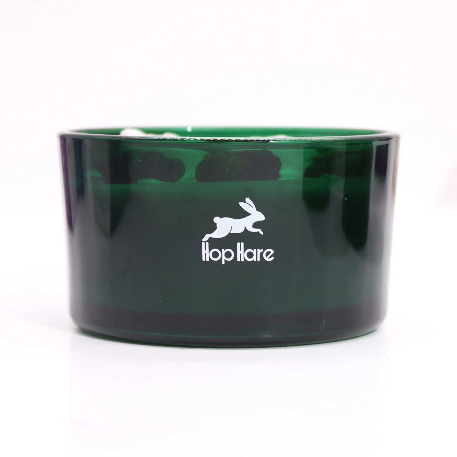 "Hop Hare Crystal Floral Candle in green glass vessel with white Hop Hare rabbit logo"