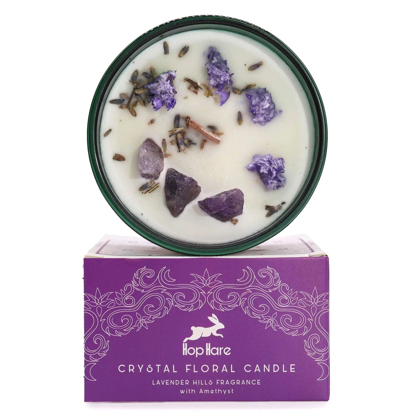 "Hop Hare Crystal Floral Candle in green glass vessel with amethyst crystals, lavender buds, and cinnamon sticks, displayed on purple Lavender Hills fragrance packaging box"