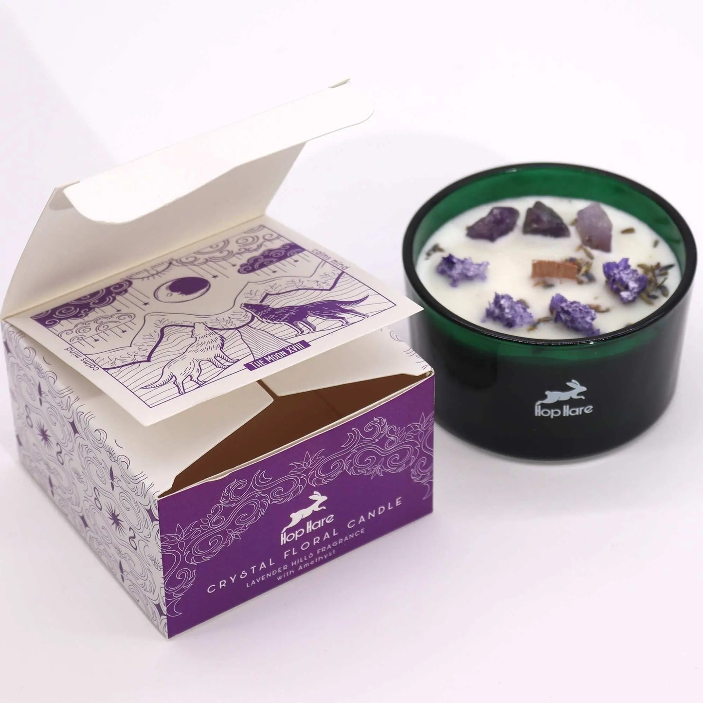 "Hop Hare Crystal Floral Candle with purple packaging box, amethyst crystals, and lavender decorations on white background"