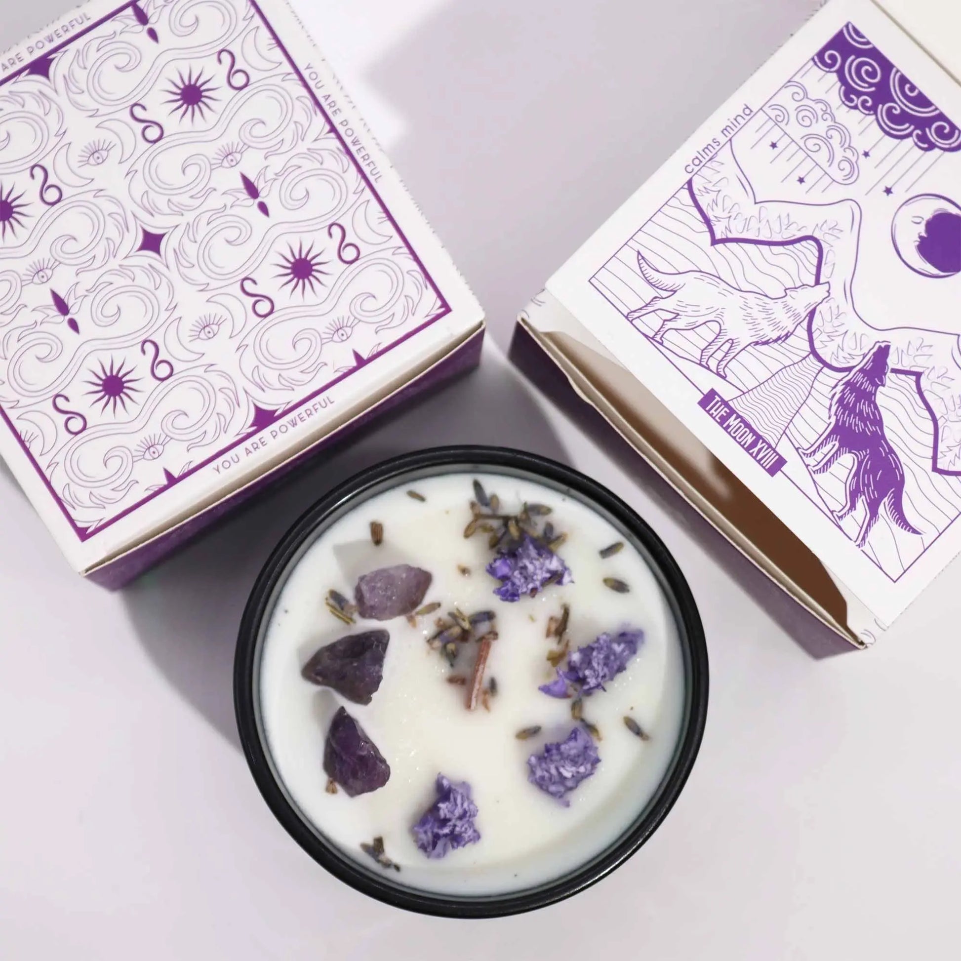 "Hop Hare Crystal Floral Candle top view with amethyst crystals, lavender buds, cinnamon sticks, and purple tarot cards showing mystical designs"